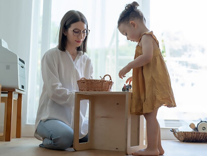 A mother and her child engage in meaningful communication and language development as the child joyfully explores and discovers new toys