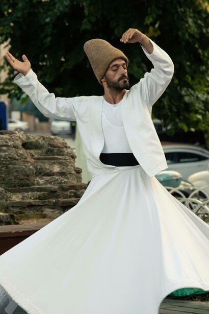 Whirling dervish with arms open