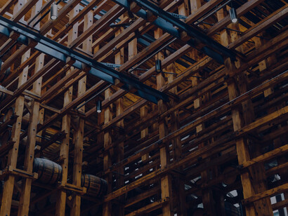 In the winery's softly lit cellar, barrels of wine age in peaceful solitude, infusing their distinct flavors and character into the maturation process