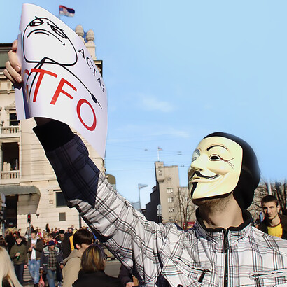 A protester wearing a Guy Fawkes mask stands at Republic Square in Belgrade, Serbia, demonstrating against the ACTA treaty