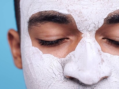 A man with a face mask on, taking care of his personal self care