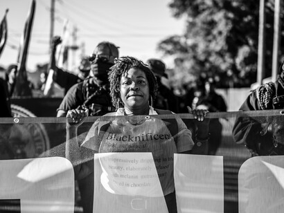 Protesters in Tulsa, Oklahoma, United States, hold a banner during a Caribbean reparations protest march