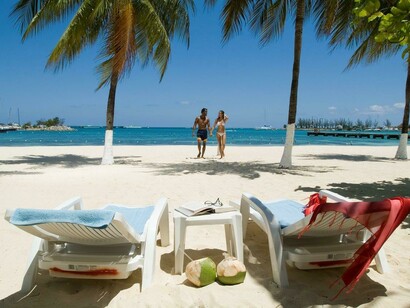Honeymoon couple strolling at a secluded Jamaican beach