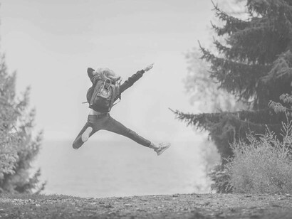 A woman jumping for joy as she celebrates being liberated
