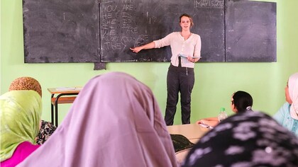 A volunteer worker teaching English in Morocco. Learning foreign languages, such as French and English, has given Moroccans access to different cultural viewpoints and improved the nation's capacity for cultural adaptation