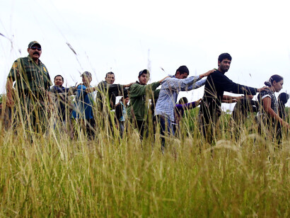 Immigrants who had been at an encampment near McAllen, Texas are escorted to a bus on April 17.