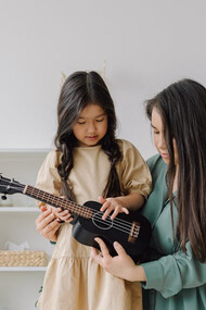 In the gentle embrace of mentorship, a young soul finds solace and strength, as the mentor shapes her thoughts with care