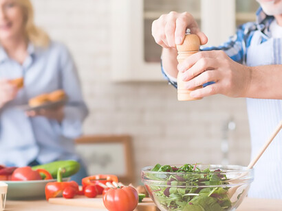 Embark on a vibrant health adventure with a senior couple embracing longevity through the antioxidant-rich Mediterranean diet, captured in a heartwarming image of them preparing a salad while exploring a digital tablet in their kitchen
