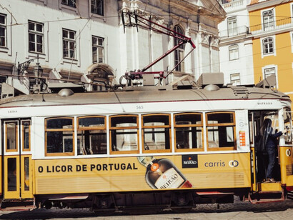 Lisbon's daytime charm, yellow and white tram on the road in Portugal