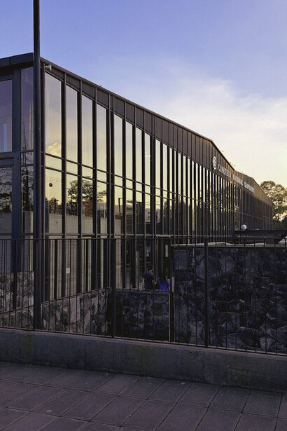 The glass façade of Cineteca Nacional Chapultepec, Mexico City, Mexico, reflecting  the fusion of contemporary architecture and the surrounding natural landscape