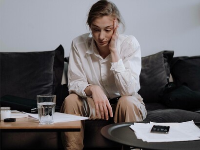 A woman feeling the effects of a headache coming on and might be in need of paracetamol