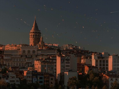 The Galata Tower in Istanbul during the sunset in the company of free-flying birds