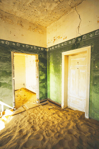 Dunes drifting through forgotten halls, Kolmanskop, Namibia, photographed by Francesco Ungaro