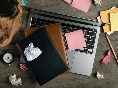 A cluttered office desk, along with the demands of a fast-paced world and digital anxiety, contributes to a sense of stress and disorganization