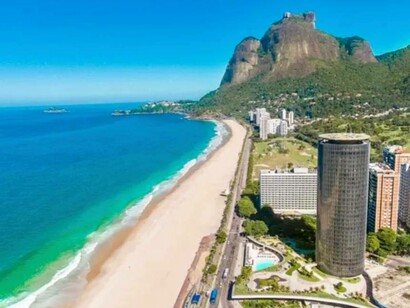 The blue sea of São Conrado, which in turn embraces the Arpoador mountains in São Conrado, in Rio de Janeiro, Brazil