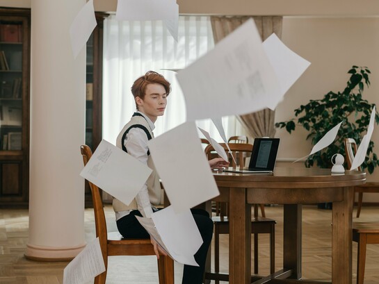 An professional surrounded by floating papers, showing how excessive planning can hinder meaningful progress
