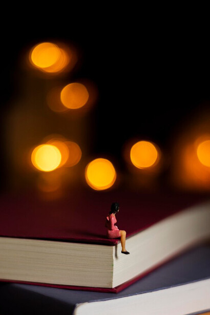 A mesmerizing composition of books and creativity, where a figure emerges from the pages, embodying the power of imagination