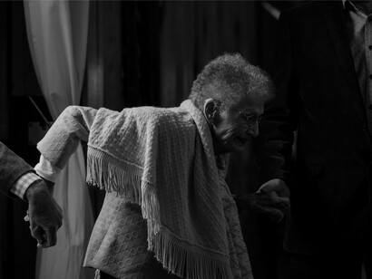 Members of our species assisting an old man in her attempts to walk