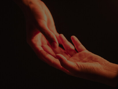 Two hands touch each other lovingly