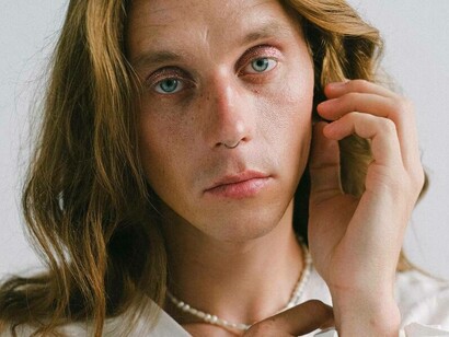 A transgender man looking directly at the camera 