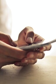 A person holding a mobile phone in their hands 