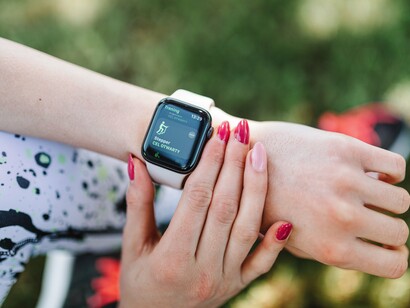 A person checking health and activity readings on a smartwatch, symbolising the role of health awareness in adapting to environmental challenges