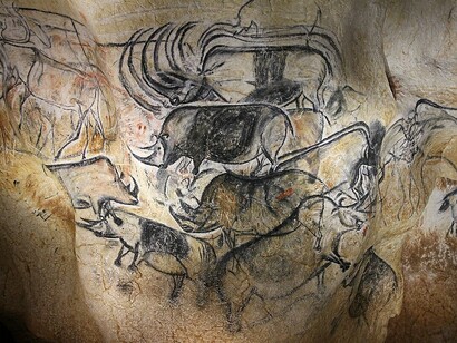 The Lions Panel (center left) in the Pont d'Arc Cave depicts runaway rhinos with multiplied horns. The artwork consists of wooden charcoal drawings with fading and flint scraping, also showing signs of wear, France
