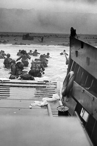 "Into the jaws of death", June 6, 1944 (Robert F. Sargent). Taken during the D-Day landings of World War II, U.S. Army soldiers of the 1st Infantry Division wade through the surf toward Omaha Beach in Normandy