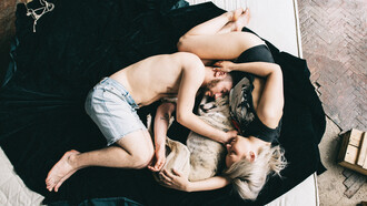 A couple curls up with their dog for some sleep