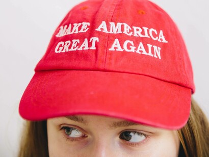 A Trump supporter wearing the MAGA cap with great delight