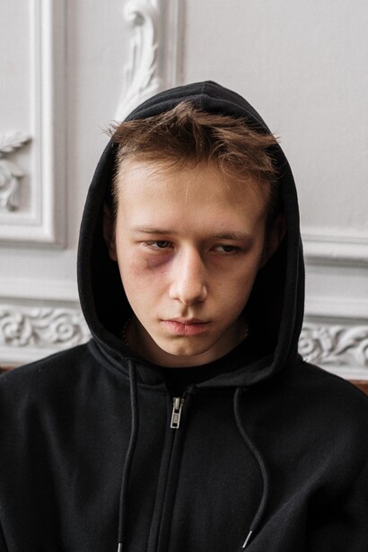 Teenager with black hoodie appears sad 