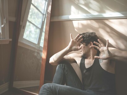 A victim from a recent crime is shielding his face as a result of a flashback from the trauma he suffered