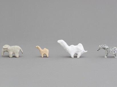Shio Kusaka, Group 1, 2014, porcelainm elephant 3: 2 1/2″ × 2 1/4" / 6.3 × 5.7 cm, camel 2: 2 1/4″ × 2 1/2″ × 1 1/4" / 5.7 × 6.3 × 3.2 cm, camel 1: 3 1/2″ × 5 1/4″ × 1 3/4" / 8.9 × 13.3 × 4.4 cm, zebra 1: 3″ × 4 1/4″ × 1 1/2" / 7.6 × 10.8 × 3.8 cm, Photo: Studio Kusaka. Courtesy of greengrassi, London