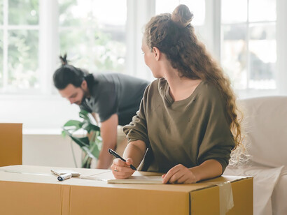 A couple is in the process of relocating, carefully packing up their belongings.