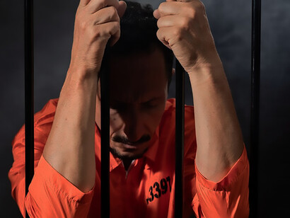 A middle-aged man incarcerated in jail, reflecting the reality of imprisonment and criminal justice reform
