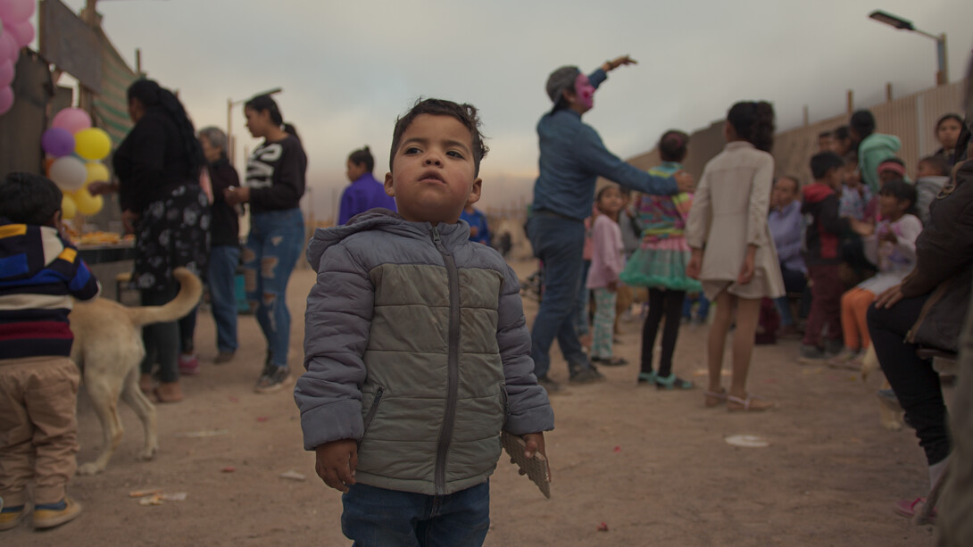 Children's Day celebration at La Mula land occupation. A child looks at the horizon, Chile