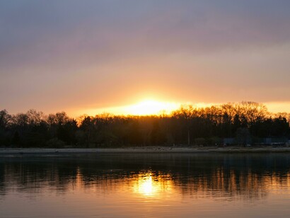 An emerging sunrise landscape over the sea bringing light to a new day