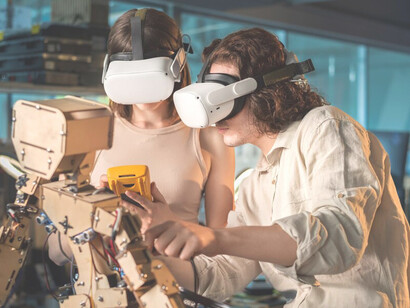 Young man and woman in protective glasses working on robotics experiments in a lab, demonstrating human-machine synergy and innovative creativity