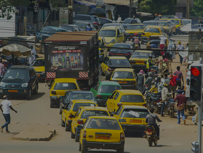 A bustling view of Nigeria's streets, filled with cars and heavy traffic, reflecting the country's urban congestion