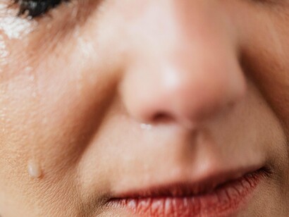 Woman with tears dripping down her face