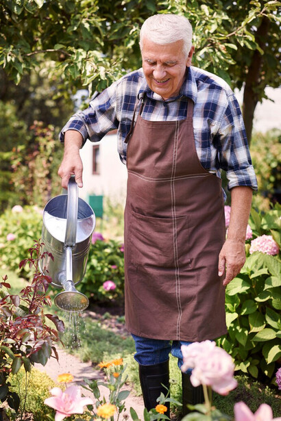 A retired man enjoying his time in the field, gardening as a way to stay active and connected to the land