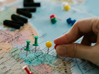 Colorful pushpins on a detailed map of Africa, representing the complex geopolitical landscape and the strategic struggles over its resources and leadership