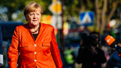 Angela Merkel in a vibrant red suit