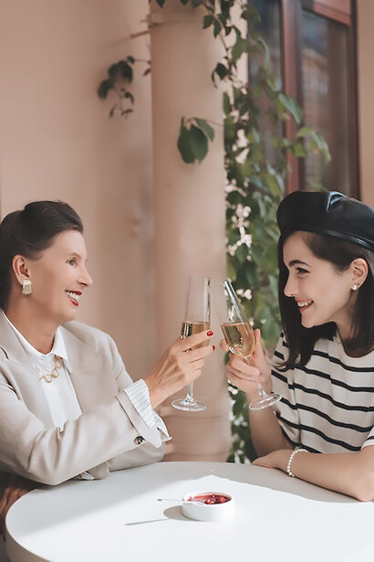 Two women drinking wine at the table