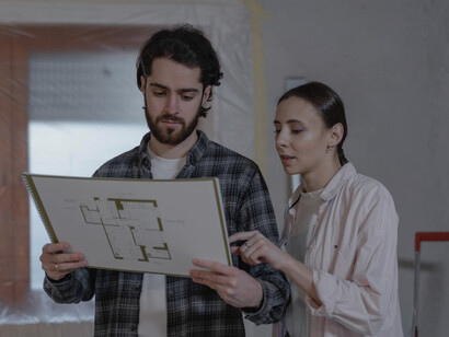 Two city planners scrutinise development plans, embodying the commitment to human dignity in urban design and governance, as enshrined in the Universal Declaration of Human Rights