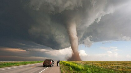Un cámara filma un tornado en una carretera desierta
