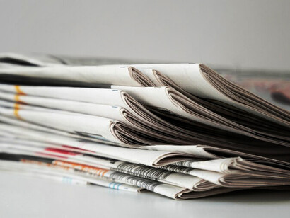 Newspapers displayed against a white background, symbolizing the essence of press and press freedom