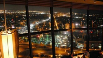 View of San Antonio from the revolving Chart House Restaurant at the Tower of the Americas at night.