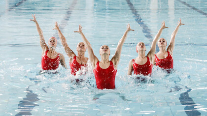 Experience the mesmerizing spectacle of synchronized dancing by women in a pool, blending grace and harmony in captivating movements