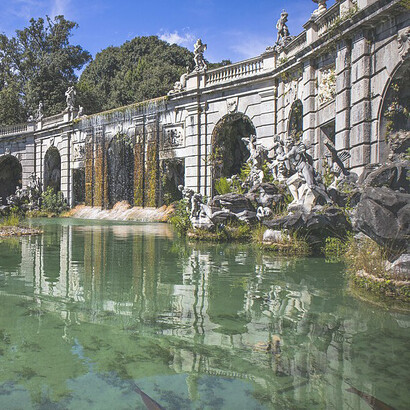 The Caserta monumental complex, designed by Luigi Vanvitelli in the late eighteenth century for Charles of Bourbon, was intended to rival Versailles and Madrid. It includes the Royal Palace, its gardens and park, a wooded area, the Carolino Aqueduct, and the San Leucio silk–producing industrial site